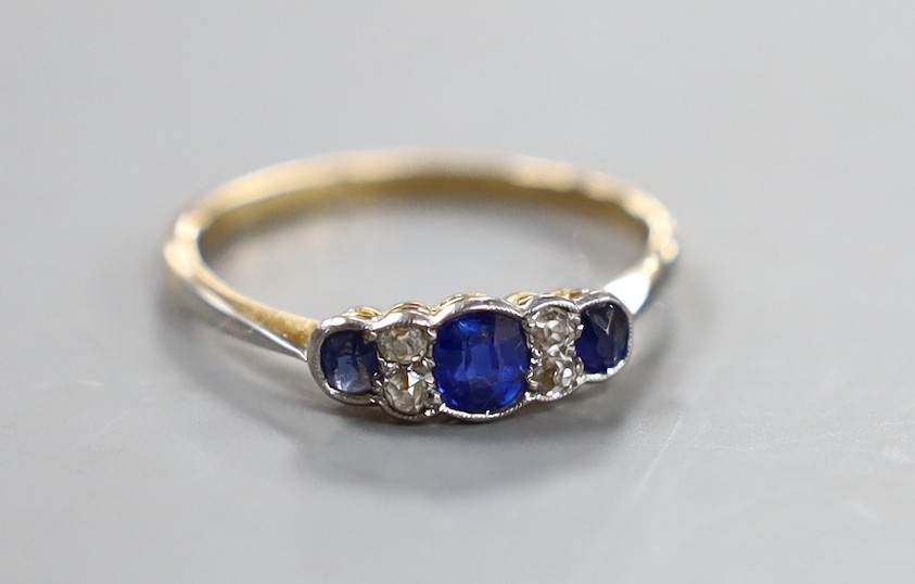A 1920's 18ct and plat, three stone sapphire and four stone diamond chip set ring, size O, gross weight 1.9 grams.